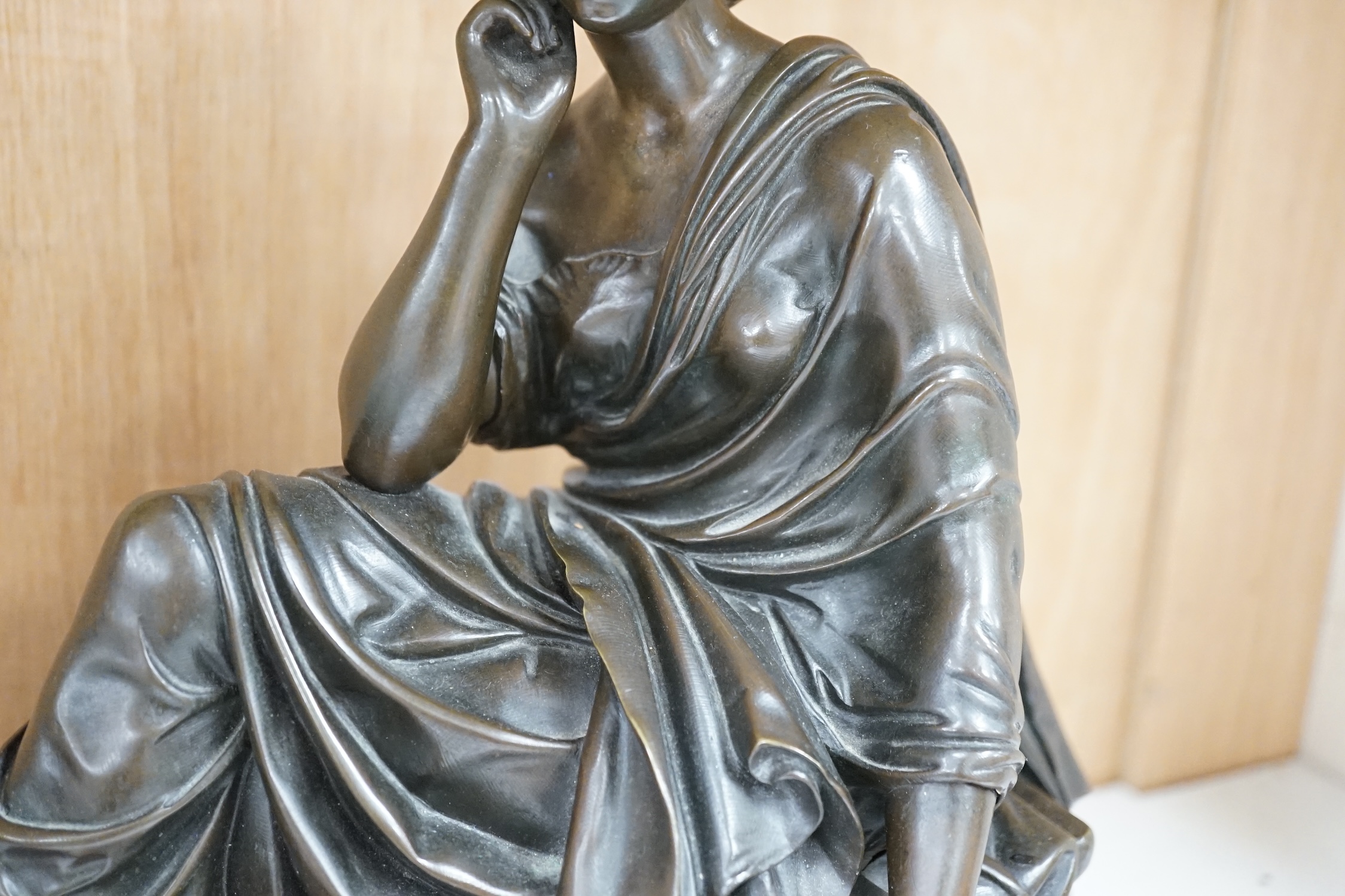 A Continental bronze of a seated young woman on a rouge marble base 37cm wide. Condition - good